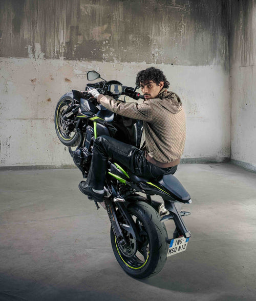Ino Casablanca sur une moto levée dans une pièce vide